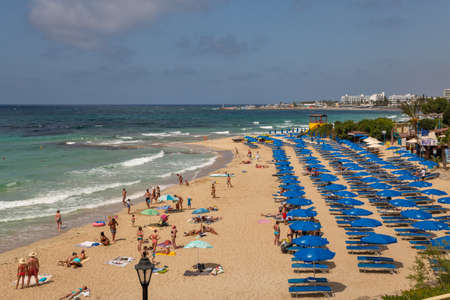 Ayia Napa, Cyprus - May 29, 2021: People visit famous Glyki Nero Beach. Ayia Napa is a tourist resort at the far eastern end of the southern coast of Cyprus.のeditorial素材