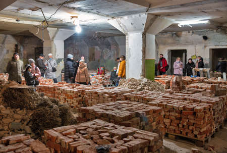 Termopil, Ukraine - February 26, 2022: People wait for the end of an air raid caused by a Russian air and missile attack in a poorly adapted bomb shelter under a shopping mall.のeditorial素材