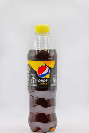 Kyiv, Ukraine - April 24, 2021: Bottle of Pepsi mango flavour zero sugar closeup against white....