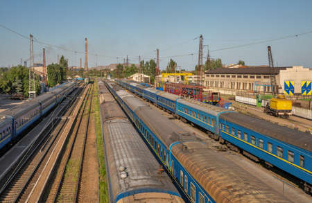 Mariupol, Ukraine - July 15, 2021: Passenger trains parked on railroad station, Azovstal in the...