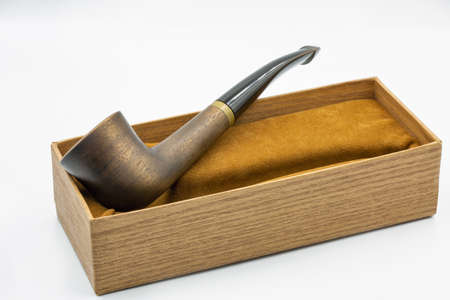 Wooden pipe for tobacco smoking closeup against white