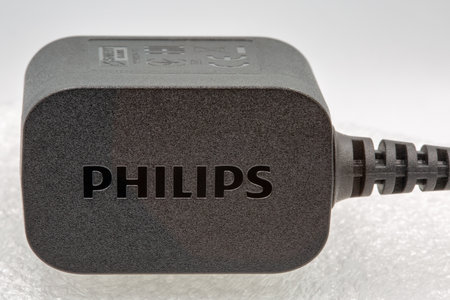 Kyiv, Ukraine - April 03, 2021: Studio shot of modern Philips mains charger closeup against white. Philips is a Dutch multinational conglomerate corporation.のeditorial素材