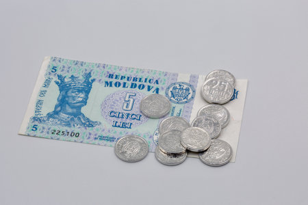 closeup on white coins and paper money of Moldova with portrait of Stephen the Great the prince of...