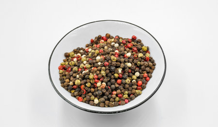 A mixture of peppers in a bowl closeup on white background