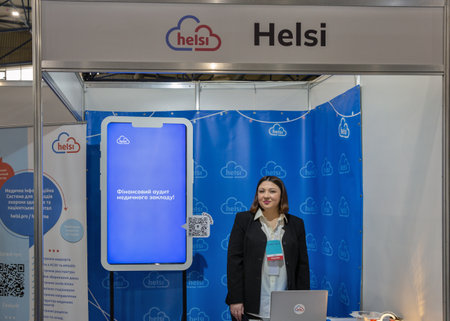 Kyiv, Ukraine - March 29, 2023: Presenter works on Helsi booth at exhibition in MVC. It is a modern Ukrainian electronic medical system for patients, doctors, public and private medical institutions.のeditorial素材