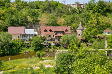 Kamianets-Podilsky, Ukraine - May 29, 2023: People visit touristic folk complex Near the River. Kamianets-Podilskyi is a city on the Smotrych River in western Ukraine, to the north-east of Chernivtsi.のeditorial素材