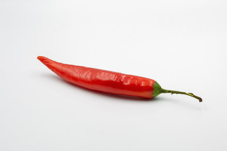 red hot chili pepper whole closeup on whi8te