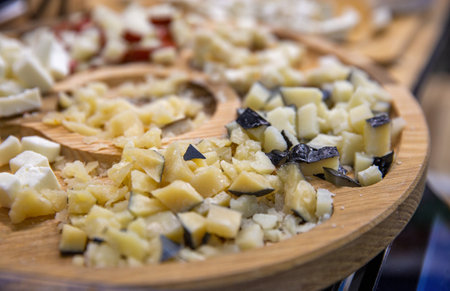 various cheeses for tasting on a wooden plate closeupの写真素材