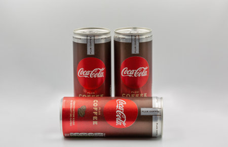 Kyiv, Ukraine - January 08, 2023: Studio shoot of Coca-Cola plus coffee cans closeup against white....