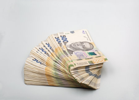 A heap of Ukrainian hryvna banknotes ready for use. Closeup on white.の写真素材