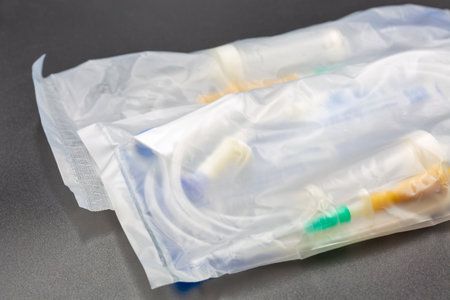 Device for infusion of blood substitutes and infusion solutions package closeup on black.の写真素材