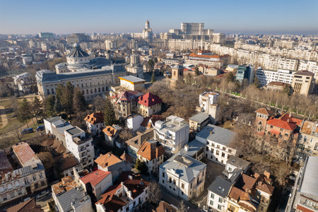 Aerial drone view over Bucharest downtown cityscape, Romania. Palace of Parliament, National Salvation Cathedral, The Patriarchal Cathedral and Boulevard Unirii.の写真素材