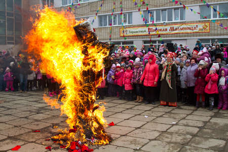 BOLSOI KAMEN, RUSSIA, - MARCH 17, 2013: The celebration of the holiday of Maslenitsa, Bolsoi Kamen, Russia, March 17, 2013. The programm - burning effigy of winter.のeditorial素材