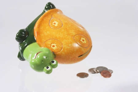 Snail bank with coins isolated on whiteの写真素材