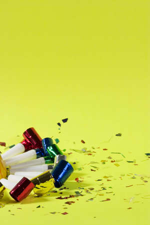 Blowers and confetti over green backgroundの写真素材