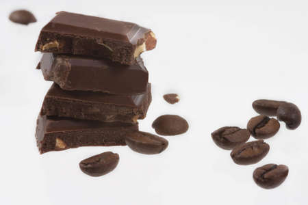 Black chocolate bar slices over white background