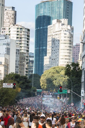 SAO PAULO, BRAZIL - June 7, 2015: crowd at the gay parade, with building the center of the city in the background, in the 19th Gay Pride Parade Sao Pauloのeditorial素材