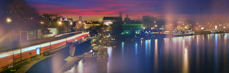 Kiev sunset on the Dnieper River, overlooking the River Station and the entire Podol, a transport line, old and new houses. Dnipro evening mist shroudedの写真素材