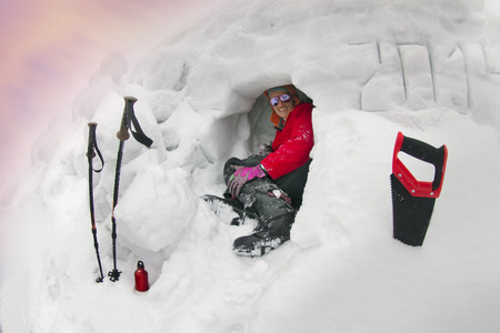 lone climber at the summit of severe weather conditions on the background of winter high mountains,...