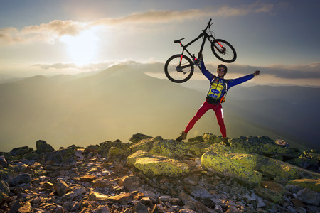 Ukraine, Vorokhta, June 29, 2016: Race marathon Ukrainian Carpathians, in Gorgany, among stone heath, mosses, lichens and alpine pine,  day and in the dark with a reliable light carbon fiber bikeの写真素材