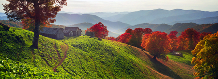 shepherds leave the pasture before the first snow and frost deserted house asylum sheds remain until next season, against the background of gold and red peaks of the Carpathiansの写真素材