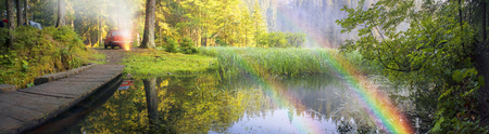 Fog after the rain covered mountain lake Ukrainian "Carpathian Eye" shore is covered with pine trees, where stoyat tent tourists and old Soviet car of local residents campers Ukraine, Verhovinaの写真素材
