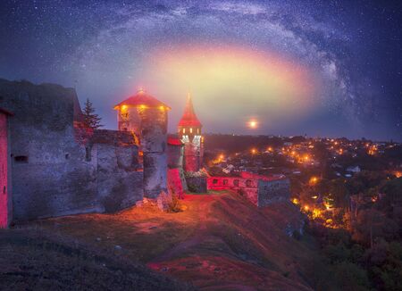 Old Castle Kamenetz-Podolsk medieval castle town of Kamenetz-Podolsk, Ukraine is one of the historical monuments. View of a beautiful evening with illumination  city lights in the night skyのeditorial素材