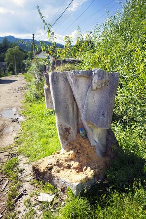 Ukraine, Yasinya, July 31, 2016: remains of Vladimir Lenin in a ditch. days of the Soviets Lenin monument  concrete idols were in every village now people recover them to the dustbin of historyのeditorial素材