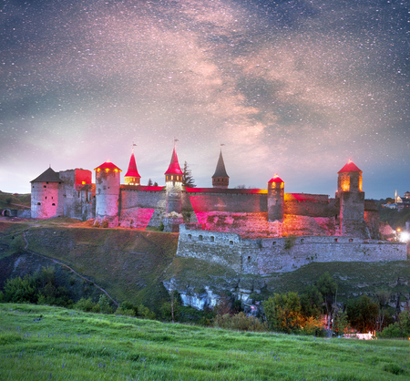 Old Castle Kamenetz-Podolsk medieval castle town of Kamenetz-Podolsk, Ukraine is one of the historical monuments. View of a beautiful evening with illumination  city lights in the night skyのeditorial素材