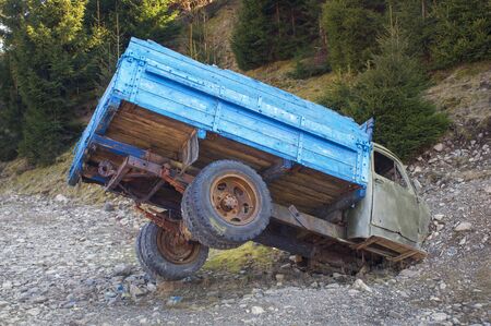 Monument in the mountains of the Ukrainian Carpathians is dedicated to the broken Soviet truck on a background of forest and mountains. It attracts tourists to the museum railwayの写真素材