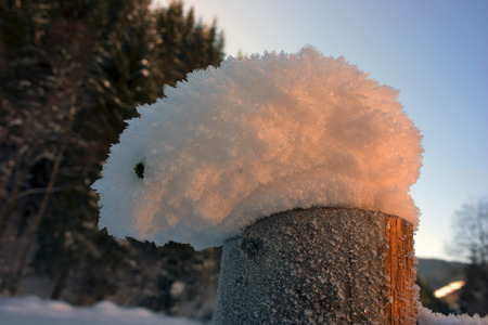 Strong wind, frost, sun rise beautiful magical patterns of snow in the mountains of Eastern Europe in the Carpathian Mountains of Ukraine on the Montenegrin ridge. Cold and freezing of water in the mountain valleysの写真素材