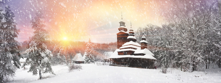 After sunset, the traditional Ukrainian village began snowfall and blizzards, snowdrifts pout and covered the roads and footpaths. Thick forest and gardens beautiful pattern on the background of skyのeditorial素材