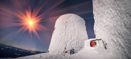 Alpine ridge Montenegro - stands on the slopes of the Ukrainian Carpathians ancient observatory built by the Poles in 1938-39, against a background of deep snow peaks and bitter cold strong wind waiting climber - extremalsの写真素材