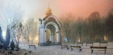 Blizzard and rain enveloped Kiev, bad weather a bad review - a romantic mood in the old St. Michael's Cathedral, on the background of the ancient walls of the monastery and bashen- trees park and garden, beautiful illumination at nightの写真素材