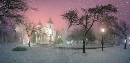 Sophia Winter evening night shot of the ancient temple of Kievan Rus during a snowfall fog, among the trees of the old monastery garden and park in front of illumination during Christmas and New Yearの写真素材