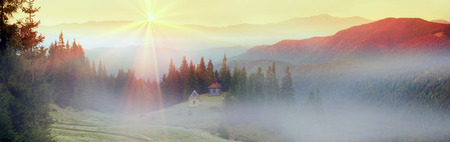 High in the mountains located Gutsulschiny tract with ancient Christian monastery, where the summer praying shepherds of sheep, cows and horses, and there is no one in the fallの写真素材