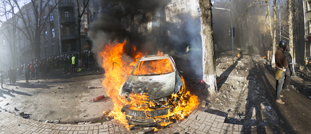 Ukraine, Kiev, 18 February 2014: Riots in the city, citizens in conflict with the power harness tires and vehicles police disperse demonstrators in Europe, protesting people fighting for their rightsのeditorial素材