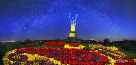 Ukraine, Kiev, June 28, 2014: spotlights colored statue of the Motherland in the colors of the...