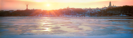 In winter, the largest river Dnieper Ukraine- chilling with ice, and at sunset the ancient walls of the Christian Orthodox monastery look beautiful, like many centuries ago in ancient historyの写真素材