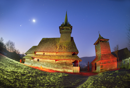 Unique 17th century wooden churches in Transcarpathia, Ukraine-churches with tall towers and slender spiers, in county Marmarosh- wooden gothic, oak. Night astronomical filming with lanterns.の写真素材
