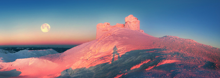 On top of the mountain Pop Ivan Montenegro is an ancient Polish observatory, especially beautiful in winter, surrounded by wild mountains. Severe weather freezes its walls, making a magic castle.の写真素材