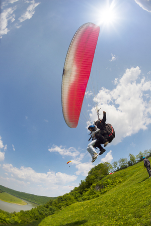 At the top of the river starting point for beautiful sport bold pilots - flying on small aircraft in the updraft in cumulus clouds in a bright sunny day in a good tail windの写真素材