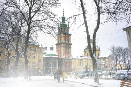 Ukraine, Lviv - January 14, 2017: New Year's Christmas walk through the ancient architectural attractions offered to tourists and visitors of the city for travelers to citizens on the square by snowfall walkのeditorial素材