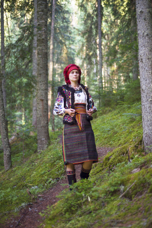 Young Ukrainian girl in an old picturesque present authentic national costume Ukrainian highlanders Gutsul on the background of wild nature Hutsulshchyna in Carpathians, Ukraineの写真素材