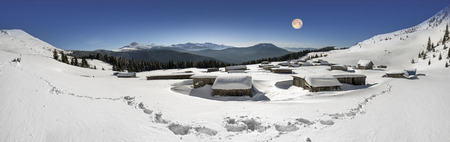 By Christmas the mountain covered with snow beautiful cover rests on top of the house and the shepherds to summer grazing sheep and spend the night there in the winter touristsの写真素材