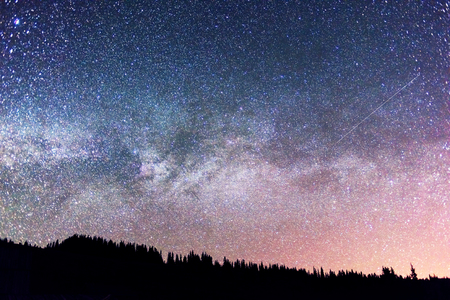Starry sky above the earth scenic natural phenomena in the atmosphere, a colorful mix of colors and tones - the distant lights of the universe galaxy star clusters, nebulae and comets meteorsの写真素材