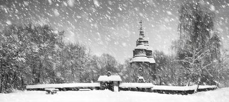 After sunset, the traditional Ukrainian village began snowfall and blizzards, snowdrifts pout and covered the roads and footpaths. Thick forest and gardens beautiful pattern on the background of skyの写真素材