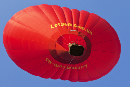 Ukraine, Kiev, 13 August 2011: The birthday girl in love - a gift from her male flight on a beautiful romantic hot air balloon on the background of sunny weather and blue skyのeditorial素材