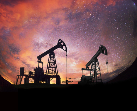 Ukraine, Carpathians night photo of the European oil rig rocking the pump on the background of the Milky Way Galaxy in the universe. Symbol of energy and ecology of planet Earthの写真素材