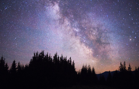 Starry sky above the earth scenic natural phenomena in the atmosphere, a colorful mix of colors and tones - the distant lights of the universe galaxy star clusters, nebulae and comets meteorsの写真素材
